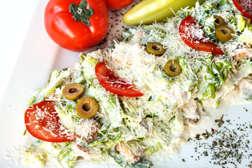 A small Caesar Salad with shredded parmesan cheese, croutons and