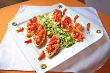 Fresh chopped tomato and basil on crostini