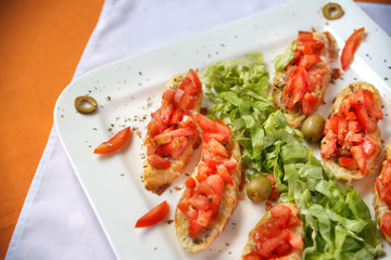 Fresh chopped tomato and basil on crostini