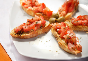Fresh chopped tomato and basil on crostini
