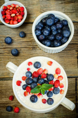 oatmeal with blueberries and strawberries in the white bowl