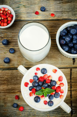 oatmeal with blueberries and strawberries in the white bowl