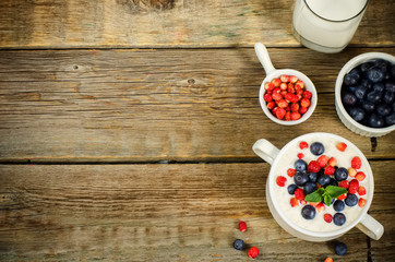 oatmeal with blueberries and strawberries in the white bowl