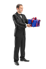 Young guy holding a wrapped present