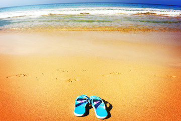 Beach sandals on tropical sandy coast