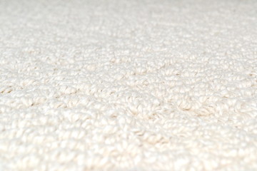 Fototapeta na wymiar Cream coloured carpet background, close up