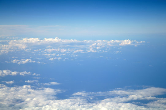clouds and blue sky seen from plane © ekulik2011