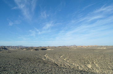  desert covered by black stones