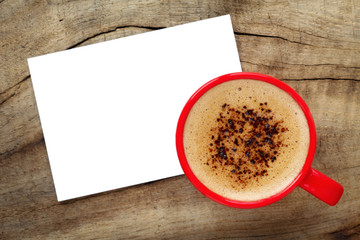 Obraz na płótnie Canvas Cup of espresso with creamy foam and a white greeting card