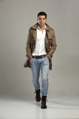 young man posing on gray background