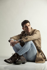 young man posing on gray background