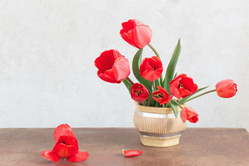 red tulips bouquet on wooden table