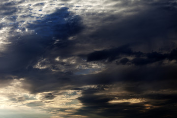 Naklejka na ściany i meble Dark sky with sunlight clouds in evening