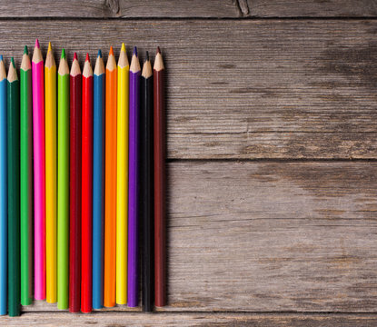 multicolored pencils on the wooden  background