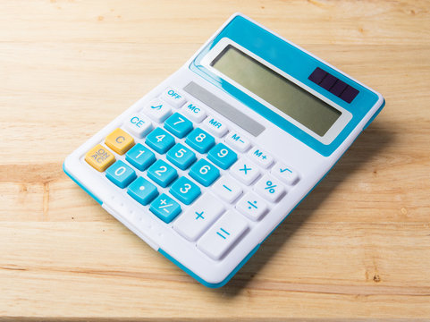 a calculator on wood background
