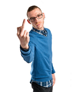 Young man doing the horn gesture over white background