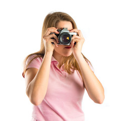 Girl taking a picture over white background