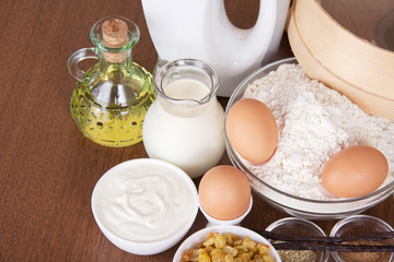 Fototapeta na wymiar Dairy products, eggs, flour, sunflower oil, raisin