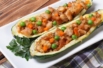 baked zucchini stuffed with meat, vegetables and cheese