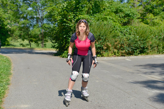 pretty young woman doing rollerskate on a track