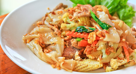 Stir fried noodles with egg, pork, green vetgetables and sauce