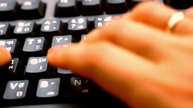 hands woman press on keyboard with thai and english language