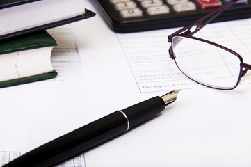 Fototapeta premium Calculator,pen, notebook and business reports