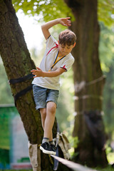 Little boy balancing on a tightrope