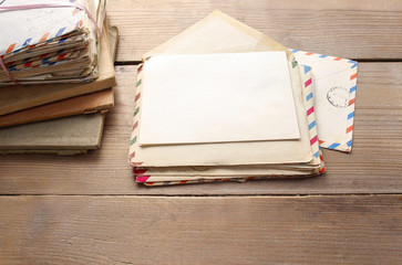 Stack of vintage letters on wooden table