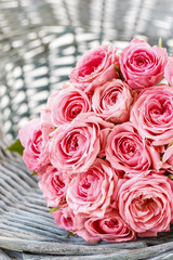 Pink roses in wicker basket