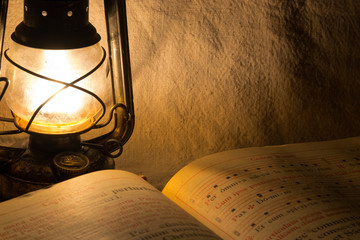 Set with an old rusty lantern and a book