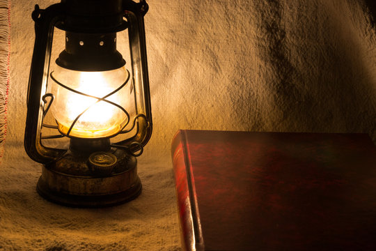 Set with an old rusty lantern and a book