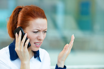 Upset woman having unpleasant conversation on phone