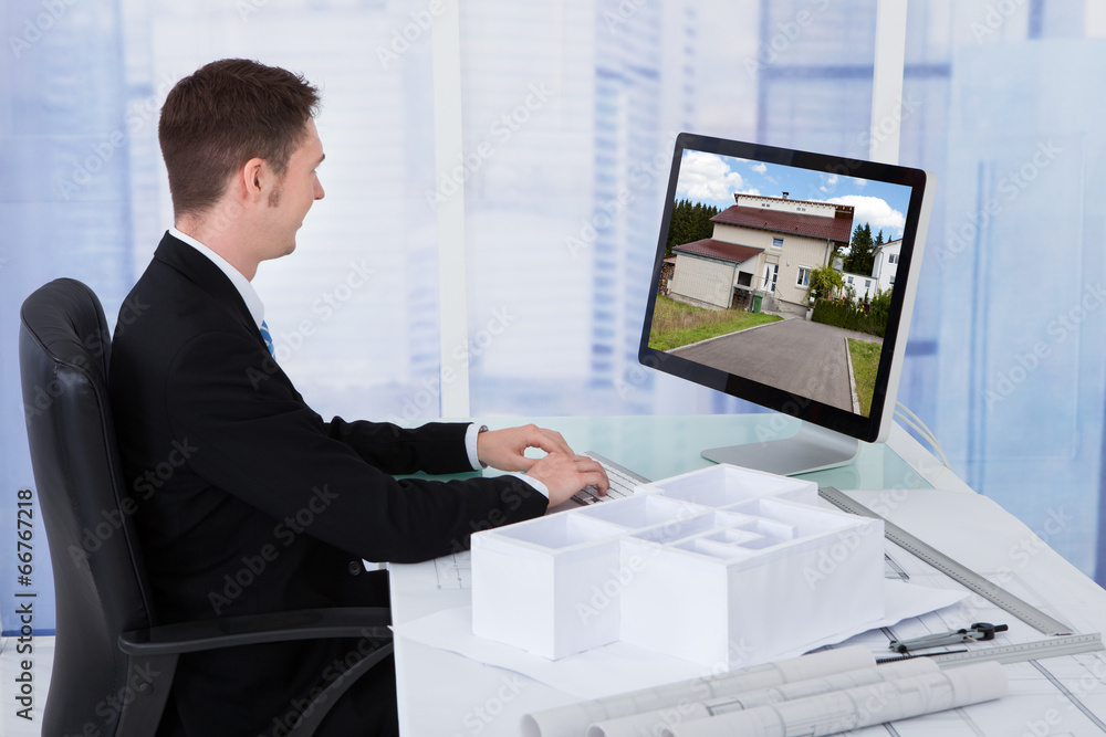 Poster Architect Browsing Property On Computer In Office