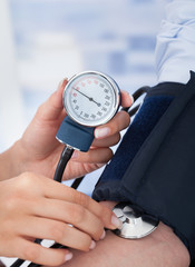 Doctor Checking Blood Pressure Of Businessman