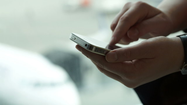 Close-up shot of female hands typing sms on smartphone