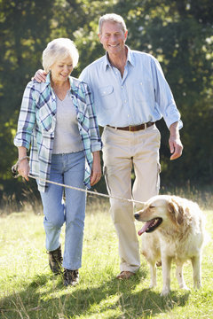 Senior Couple Walking Dog