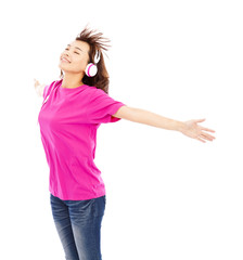 Young beautiful woman enjoying the music and opening arms