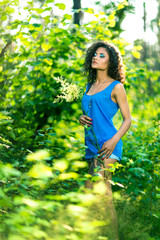Fototapeta premium Young relaxing female lying on her stomach in the grass