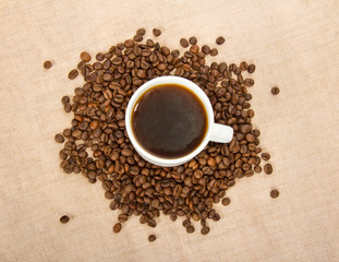 Fototapeta na wymiar White cup with coffee and grain