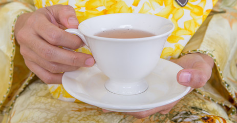 Female hands holding a cup of tea