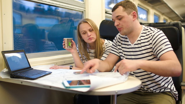 Young people working with plan in the train