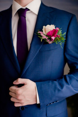 Hands of wedding groom getting ready in suit