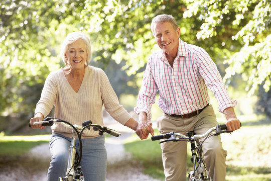 Senior couple cycling in park