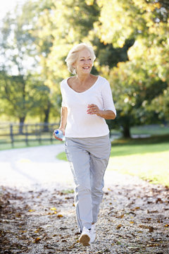 Senior Woman Running In Park