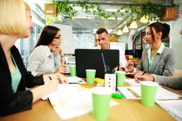 Business people having meeting around table in office