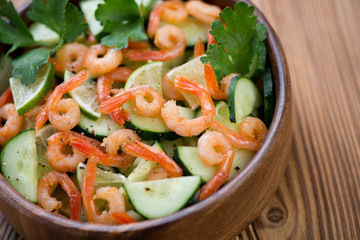 Close-up of shrimps, cucumbers and lime salad, horizontal shot