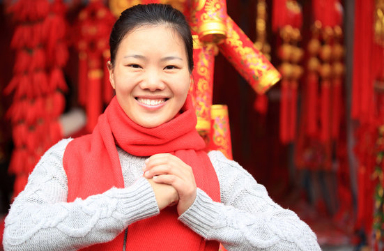 young asian woman wishing you a happy chinese new year 