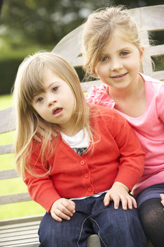Girl with younger Downs Syndrome sister