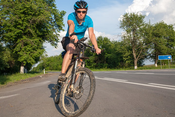 Fototapeta premium Man cycling at the road